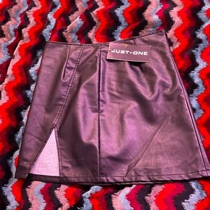 Black fake leather mini skirt with slit. Size XL. Just one brand.